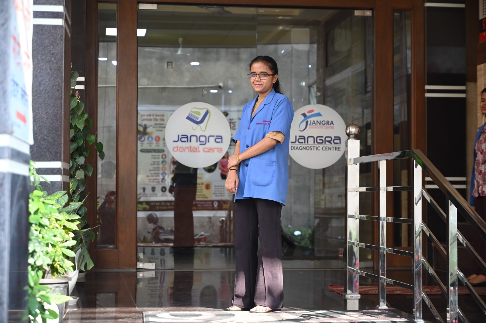 Clinical care assistant standing at the entrance of Jangra Diagnostic Centre & Dental Care